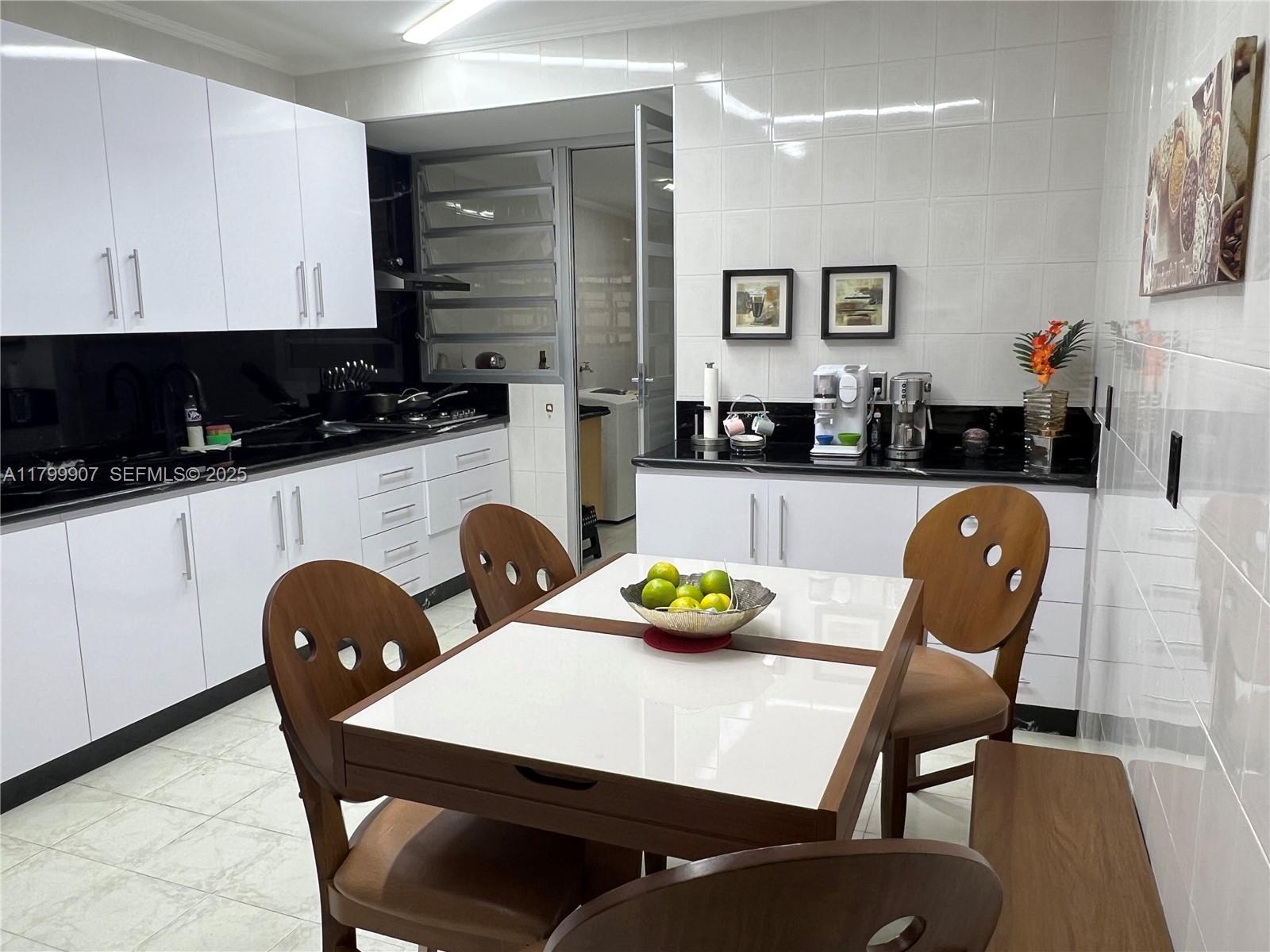 undefined, SP 13930 - Photo 10 of 26 a kitchen with a dining table and chairs