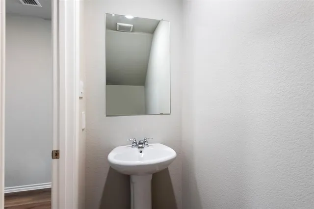 a bathroom with a sink a mirror and toilet