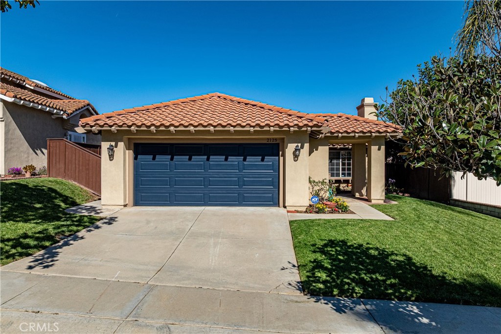 2125 Tehachapi Drive Corona, CA 92879 - Photo 1 of 1 a front view of a house with a garden