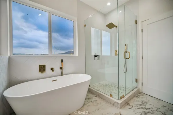 a spacious bathroom with a toilet a sink and mirror