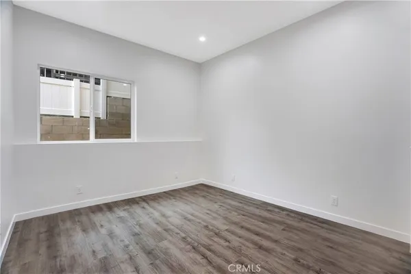 an empty room with wooden floor and closet