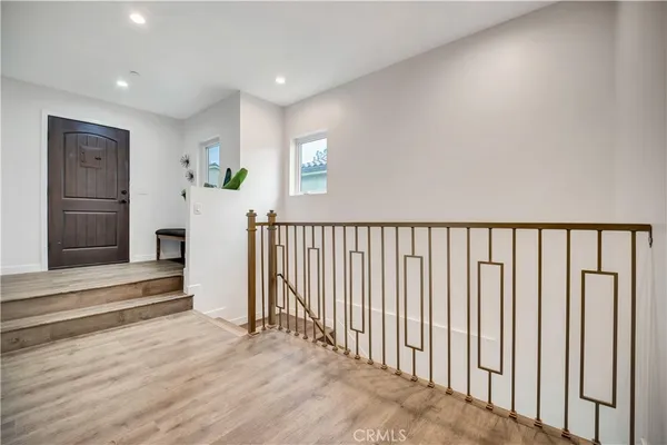 a view of a livingroom with wooden floor and white walls