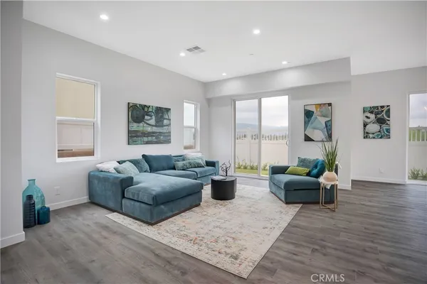 a living room with furniture and floor to ceiling windows