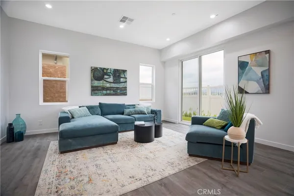 a living room with furniture and a potted plant