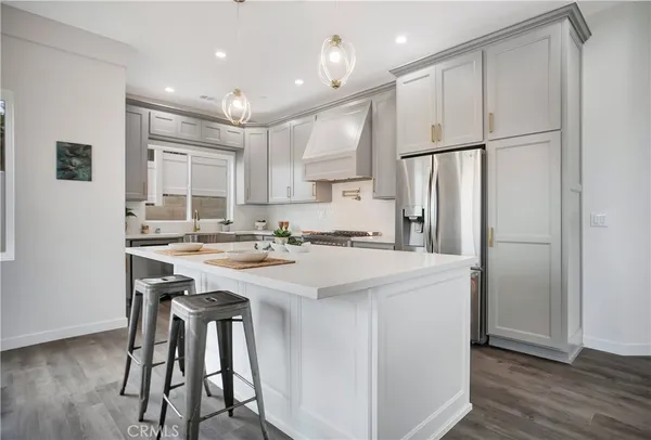 a kitchen with stainless steel appliances granite countertop a stove and a sink