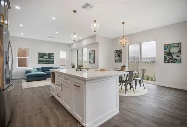 a kitchen with white cabinets and a stainless steel refrigerator stove