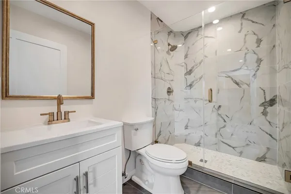 an empty room with wooden floor and window