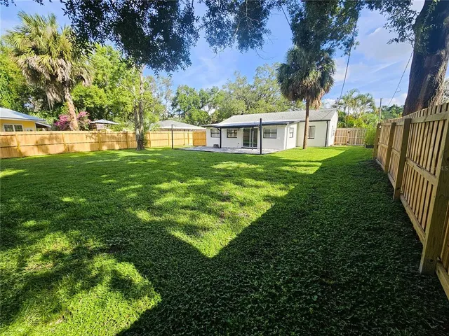 a view of a house with a backyard