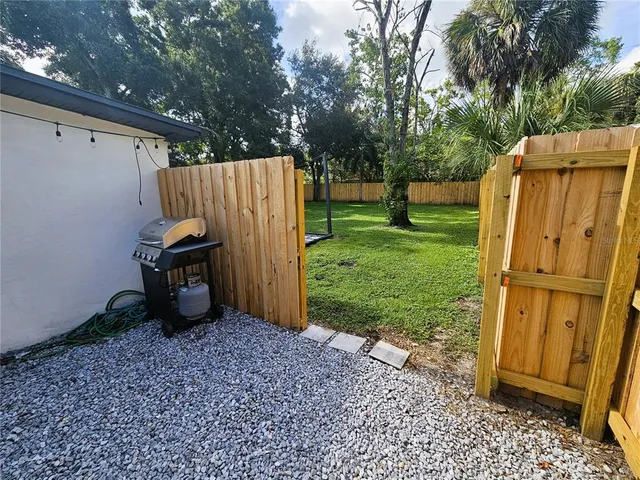 a view of a house with a backyard