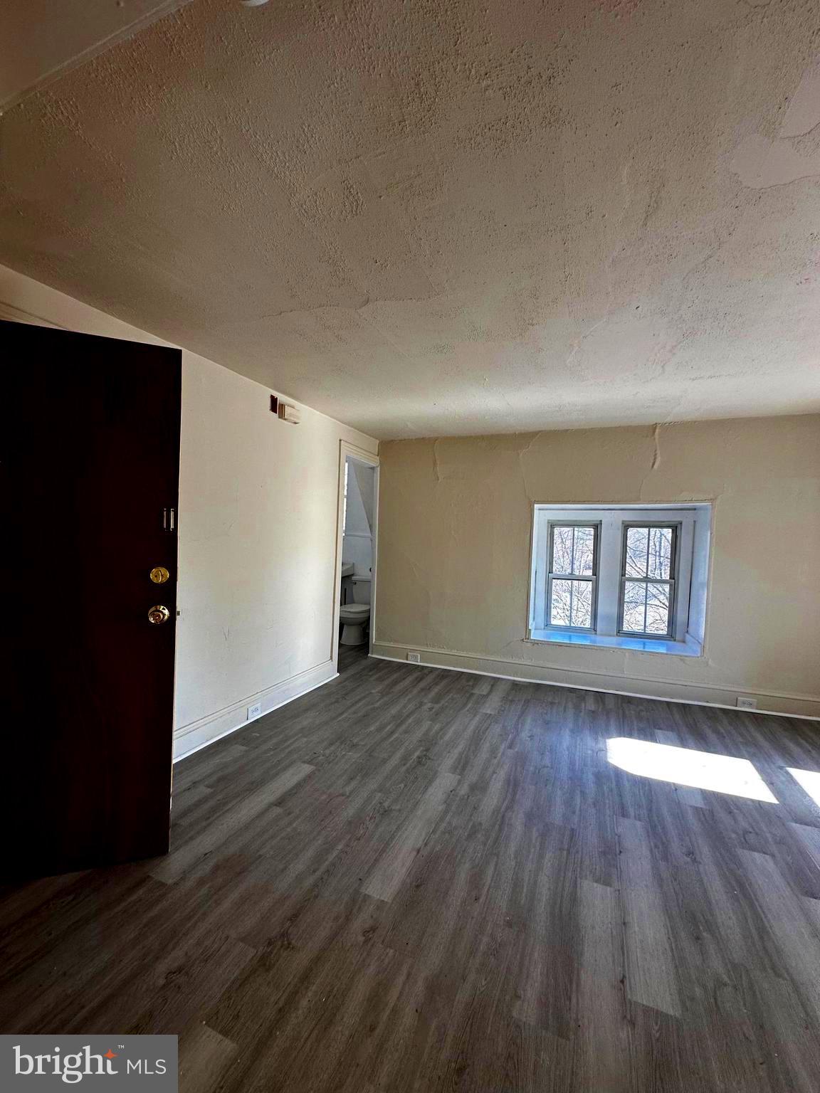 26 South State Street Dover, DE 19901 - Photo 14 of 16 a view of a room with wooden floor and window