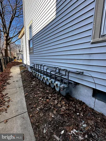 a view of a street with wooden fence