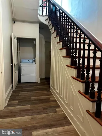 a view of entryway and hall with wooden floor