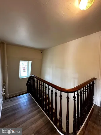 a view of hallway with wooden floor