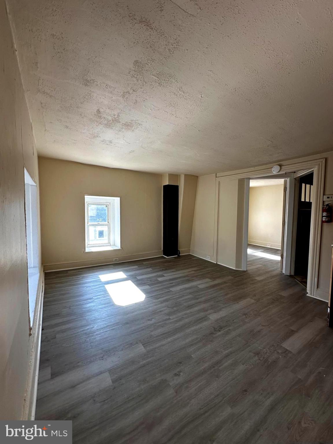 26 South State Street Dover, DE 19901 - Photo 10 of 16 a view of empty room with window and wooden floor