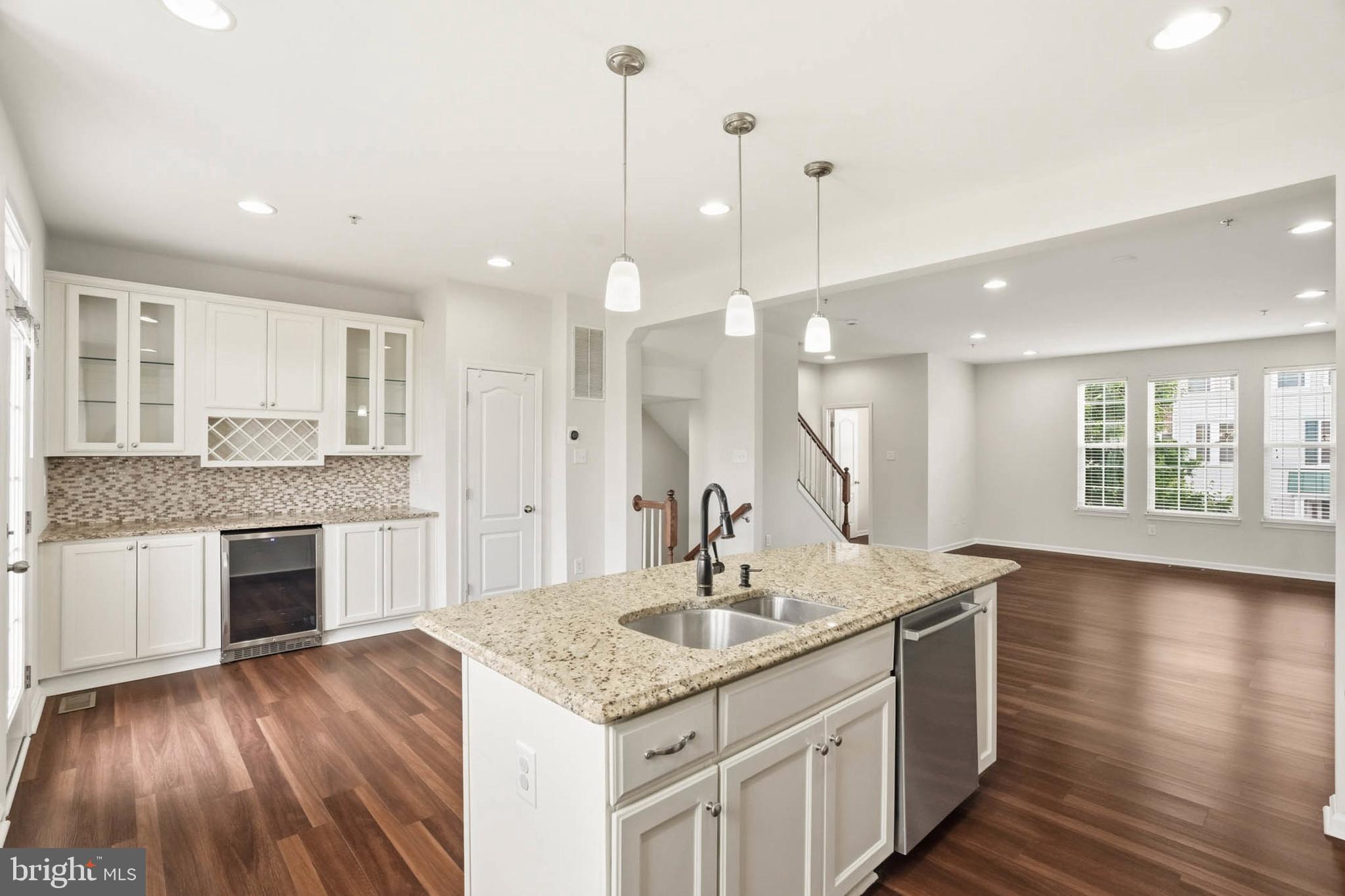 9817 Solar Course Laurel, MD 20723 - Photo 4 of 59 a kitchen with a sink cabinets and wooden floor