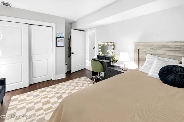 a bedroom with two beds and a potted plant