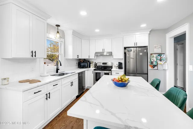 a dining room with furniture a chandelier and wooden floor