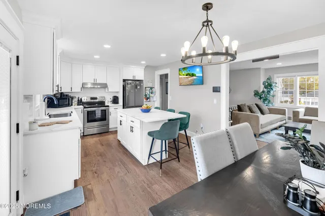 a view of a dining room with furniture and a chandelier
