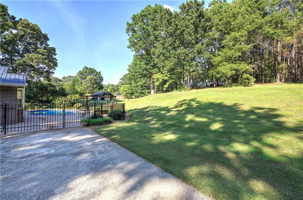 408 Mac Johnson Road Northwest Cartersville, GA 30121 - Photo 58 of 79 a view of a yard with plants and large trees