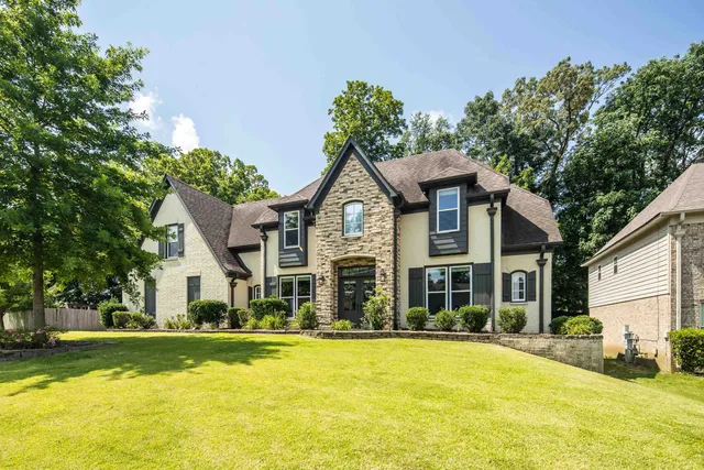 a front view of house with yard and green space
