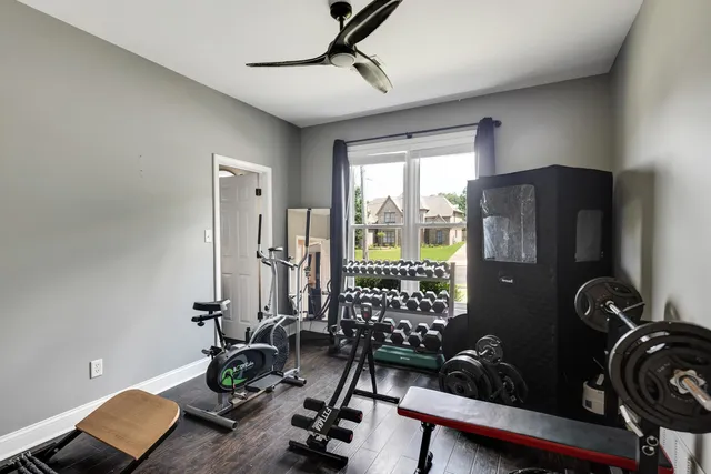 a room with gym equipment and large window