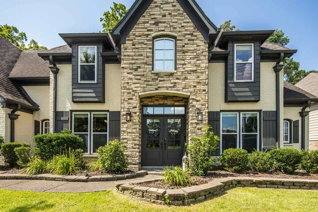 a front view of a house with garden