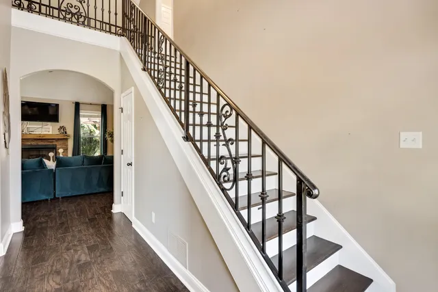 a view of staircase with wooden floor and a rug