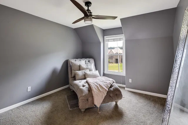 a bed sitting in a bedroom next to a window