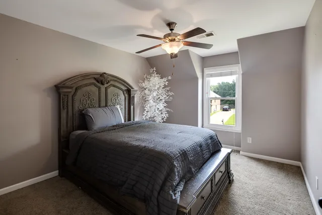 a bedroom with a bed and window