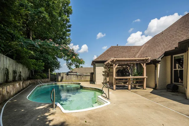 a view of a house with backyard patio and fire pit
