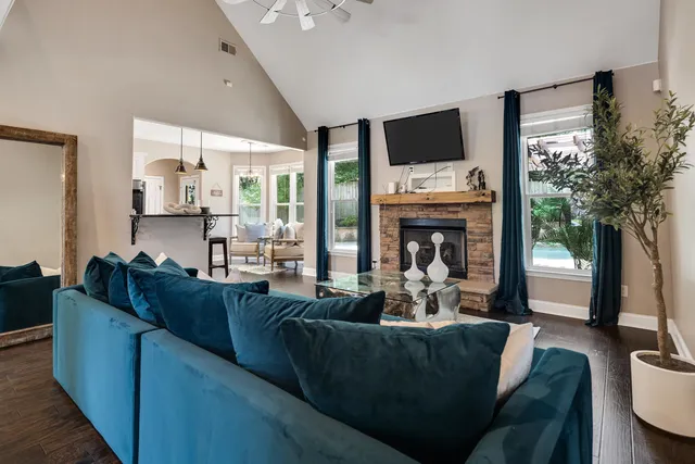 a living room with furniture a fireplace and a flat screen tv