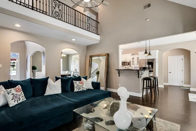 a living room with furniture or wooden floor and a chandelier