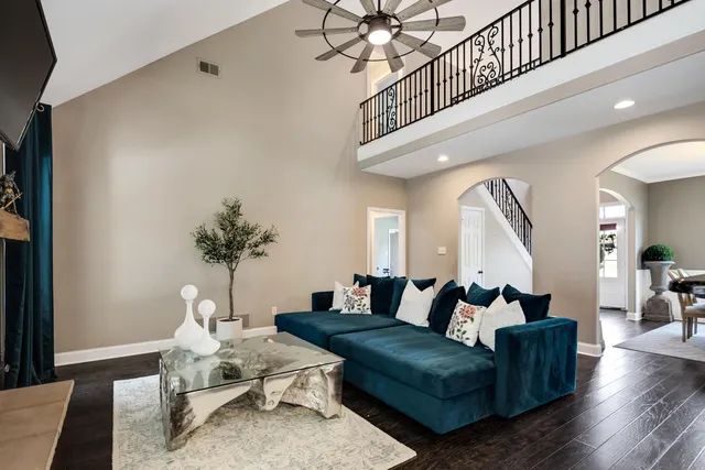 a living room with furniture and a potted plant
