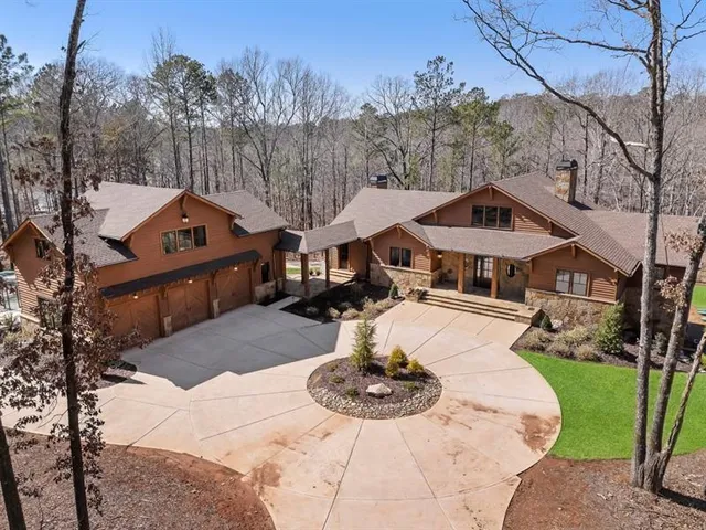 a living room with furniture fireplace and a large window