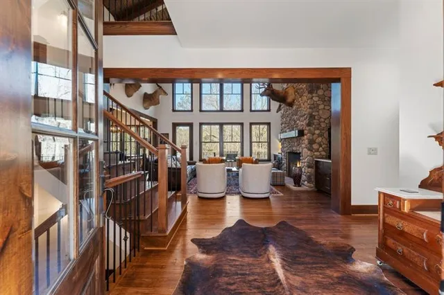 a open kitchen with stainless steel appliances granite countertop a stove a refrigerator a sink dishwasher a dining table and chairs with wooden floor