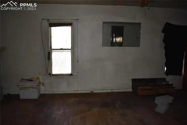 a room with a window and a wooden floor