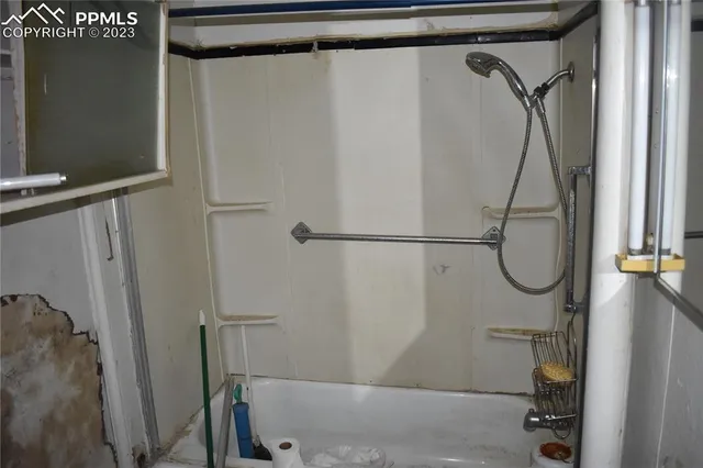 a bathroom with a glass shower door