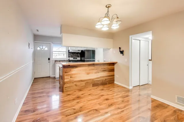 a view of a kitchen with a sink and a refrigerator