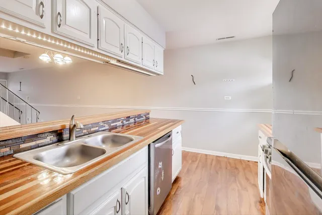 a kitchen with a sink a stove and cabinets