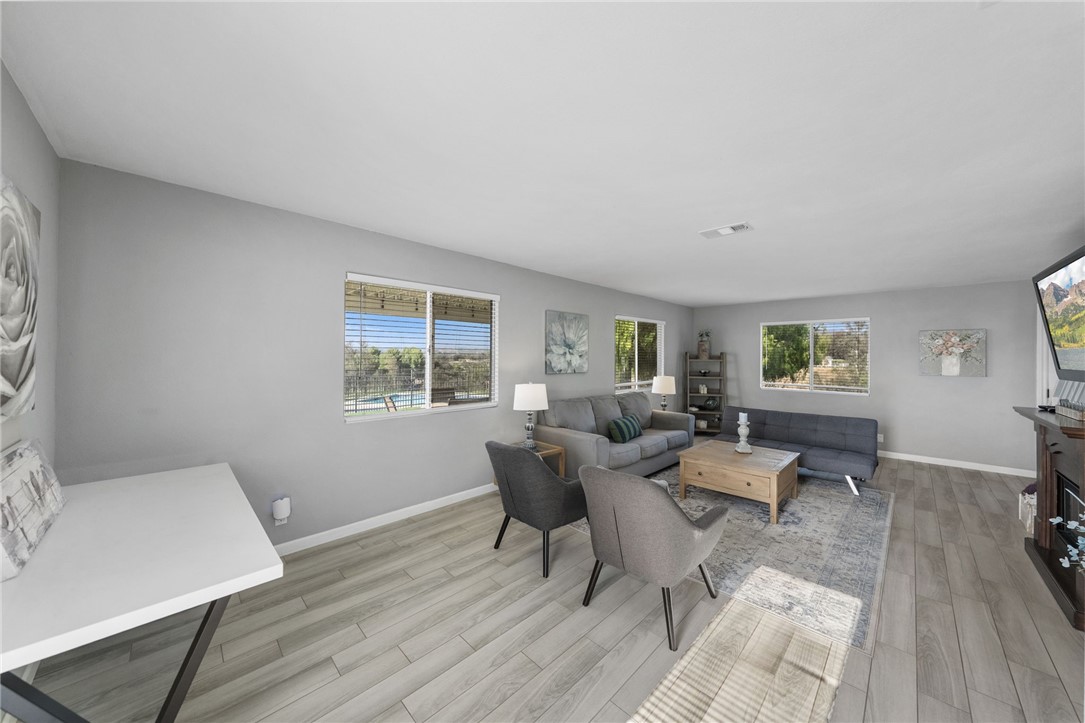 35825 Meadow Ridge Road Temecula, CA 92592 - Photo 40 of 75 a living room with furniture and a wooden floor