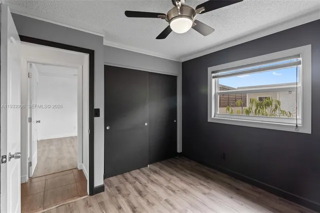 a kitchen with stainless steel appliances granite countertop a refrigerator a stove and a sink with wooden cabinets