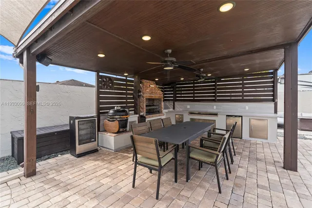a view of a patio table and chairs under an umbrella