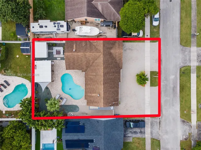 an aerial view of residential houses with outdoor space
