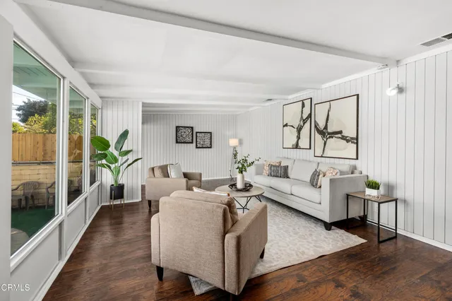 a living room with furniture and a large window