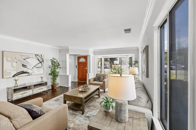 a living room with furniture and a floor to ceiling window