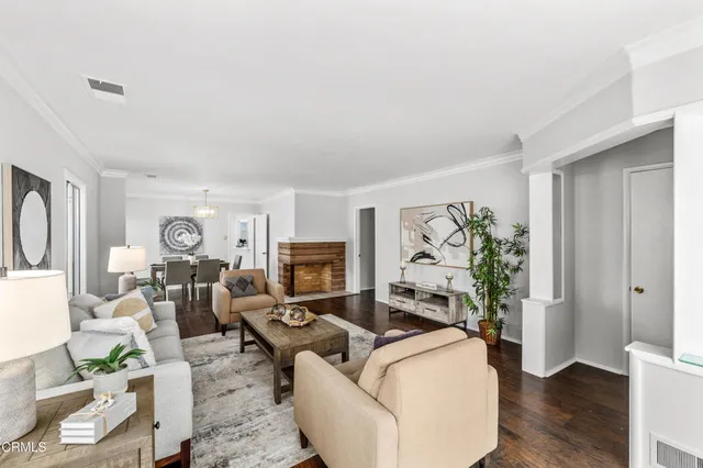 a living room with furniture fireplace and a window