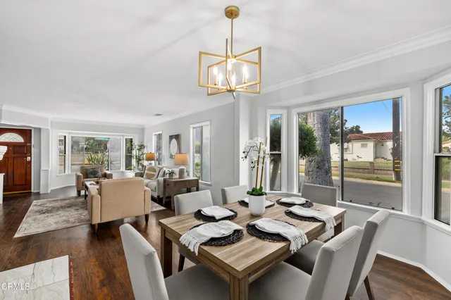 a view of a dining room with furniture wooden floor and chandelier