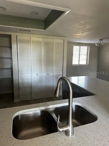a view of a sink a counter space and a faucet in a kitchen
