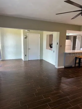 a view of a livingroom with wooden floor and staircase