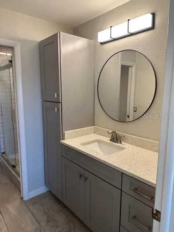 a bathroom with a sink and a mirror